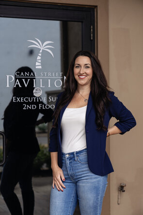 Photo of Britney Beck of Hi-Wire HR Consulting, standing in front of office door