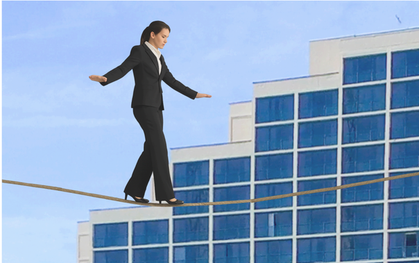 Photo of Woman on tightrope Photo of Woman in business attire walking on a tightrope